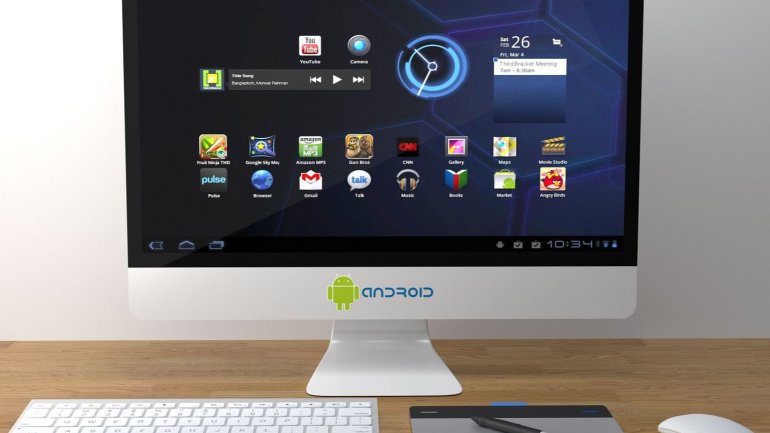-	Sobre una taula de fusta hi ha un ordinador de sobretaula amb un teclat, un ratolí i una tauleta gràfica amb un llapis digital. A la pantalla es mostra un escriptori amb diverses icones d'aplicacions i widgets, sobre un fons fosc.
