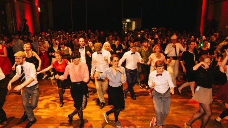 Grup de persones ballant una coreografia de Shim Sham en una sala de ball